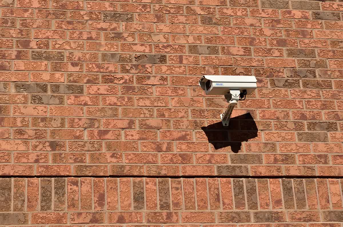 CCTV cameras mounted on an outdoor wall — IP and IK ratings are hard requirements outside