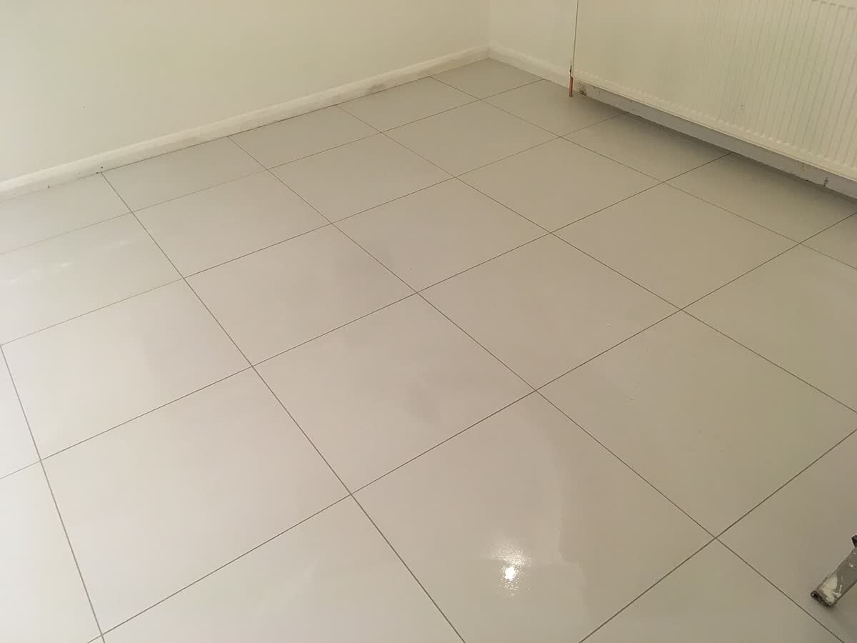 Finished floor of large-format polished porcelain tile, where joints and flatness are the acceptance points