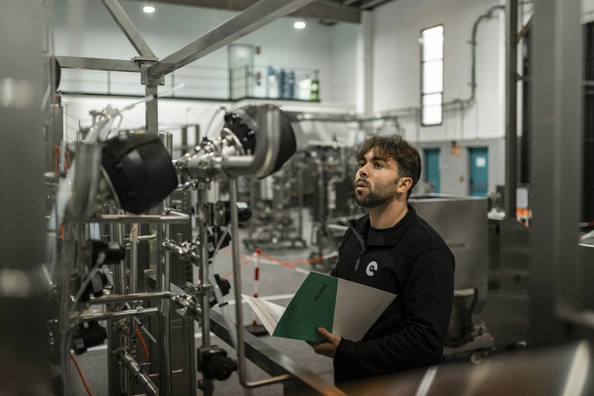 Checking production and inspection records inside a northern factory workshop