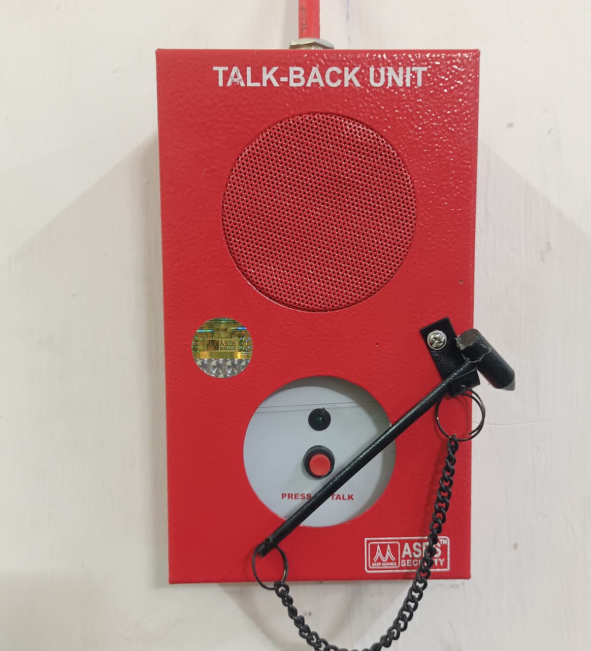 Red fire telephone talk-back unit mounted on a wall