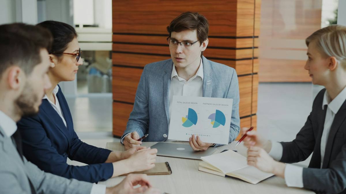 Sourcing team reviewing quote details in a factory meeting room