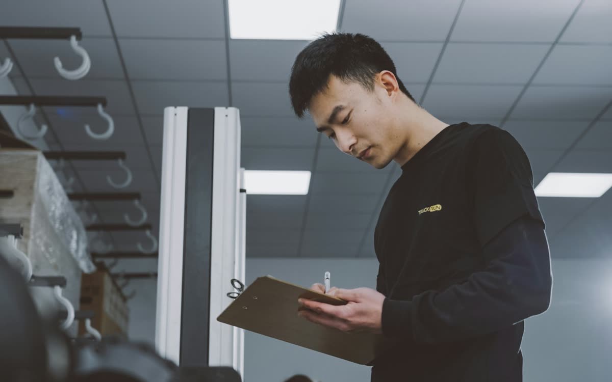 Inspector checking a production batch against the AQL sampling plan