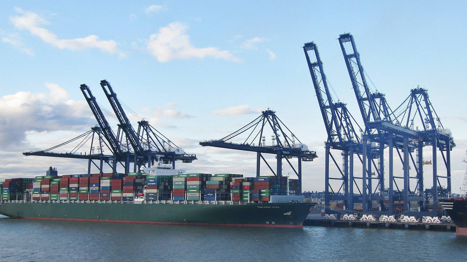 Stacked export pallets and containers ready for shipping from China to the UK and Europe